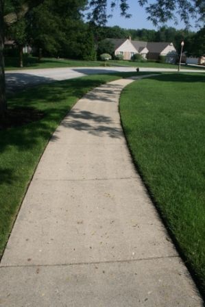 dirty concrete sidewalk cleaned by Paver Protector 